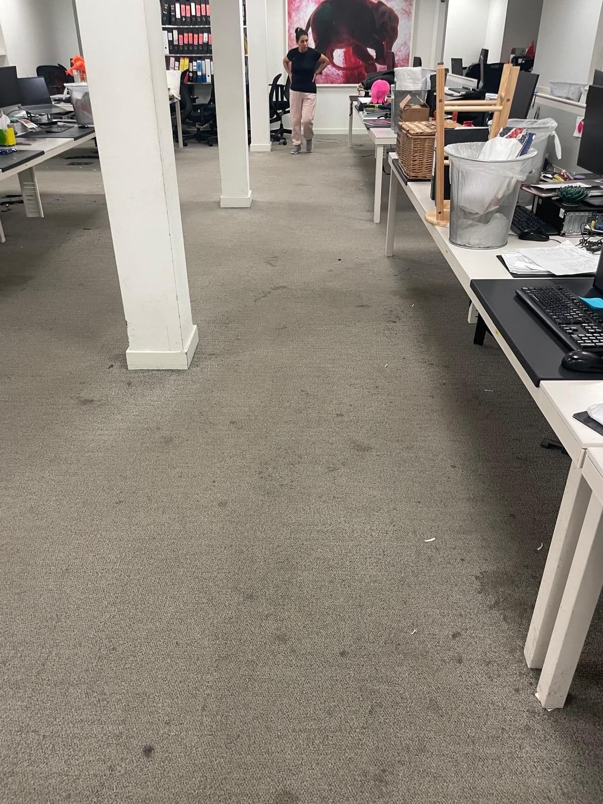 Before: open-plan office carpet with dark stains and debris between the desks