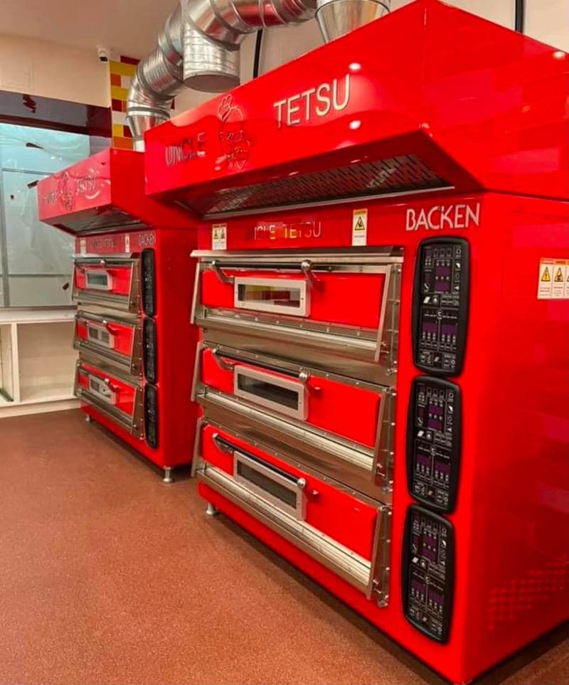 Bakery with red deck ovens and a cleaned resin floor