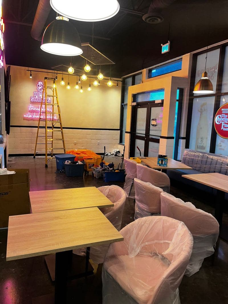 Bar lounge with pink velvet seating and wooden tables