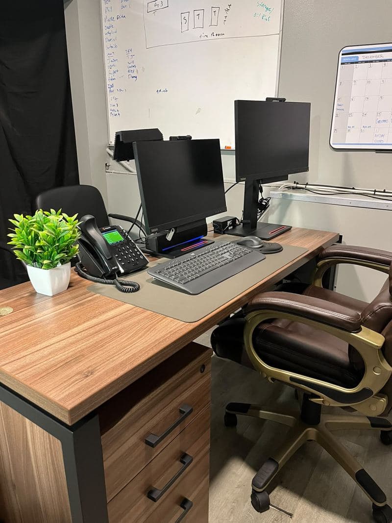 Office workstation with monitors and a wiped-down desk