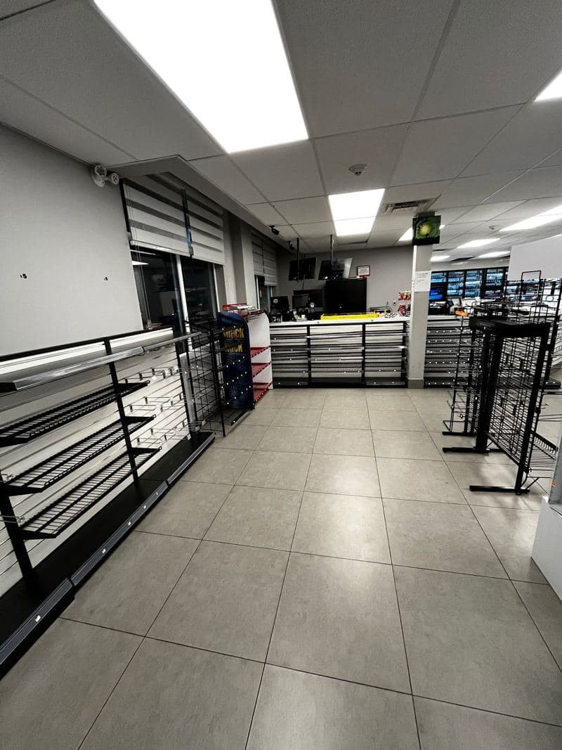 Retail unit with clean grey floor tiles between the racking