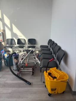 Cleaning kit on site: a backpack vacuum, a mop bucket with wringer and a folded ladder